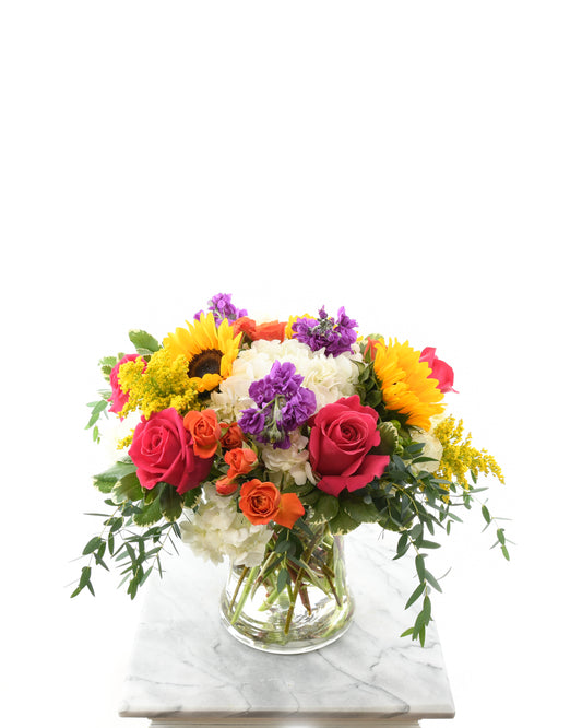Bright mixed bouquet with sunflowers, roses, and hydrangeas for celebrations – Brazos Floral Houston
