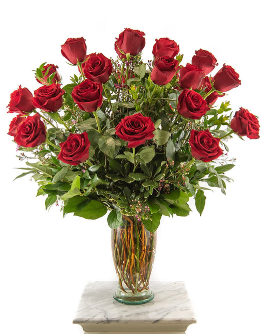 Red rose bouquet in tall glass vase for Valentine’s Day – Brazos Floral Houston
